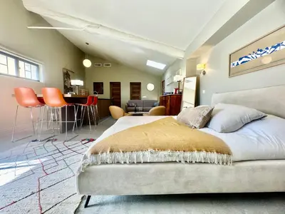 a bedroom with a bed and a living room at La palasse in Le Thor