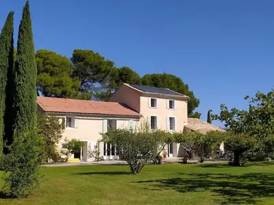 a large white house with trees in a yard at Gîte la Cigale en pleine campagne in Carpentras