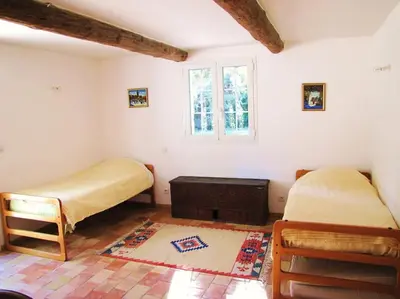 a bedroom with two beds and a window at LUBERON - AIR CONDITIONING VILLA - 4 BEDROOMS - 4 BATHROOM in Lourmarin