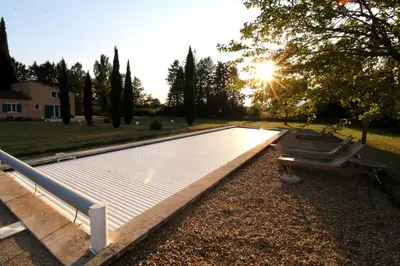 a solarium in a yard with the sun setting at LUBERON - AIR CONDITIONING VILLA - 4 BEDROOMS - 4 BATHROOM in Lourmarin