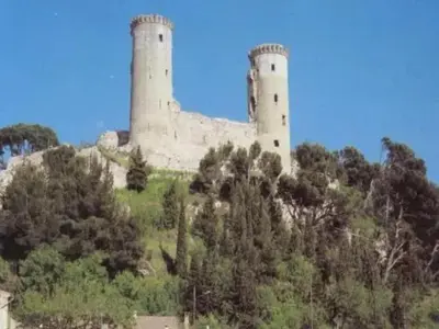 a castle on top of a hill with trees at Villa charmante à Châteaurenard avec piscine privée in Châteaurenard