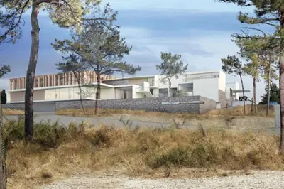 a house on a hill with trees in the foreground at Les Merles : joli studio dans la campagne Aixoise. in Venelles