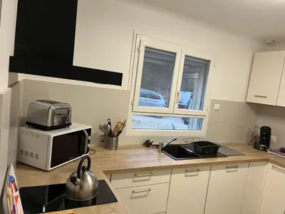 a kitchen with a microwave and a stove top oven at Villa dans la forêt provençale in Jouques