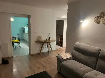 a living room with a couch and a table at Appartement privatif avec extérieur in Aubignan