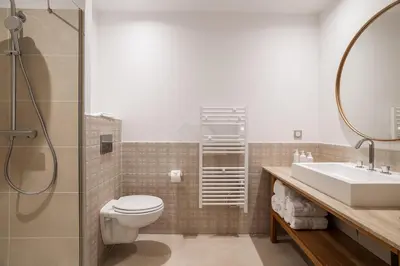 a bathroom with a toilet and a sink and a shower at Setclub Hôtel & Spa Aix-en-Provence in Aix-en-Provence