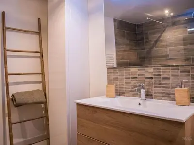 a bathroom with a white sink and a mirror at Charmant T1 calme et reposant in Saint-Andiol