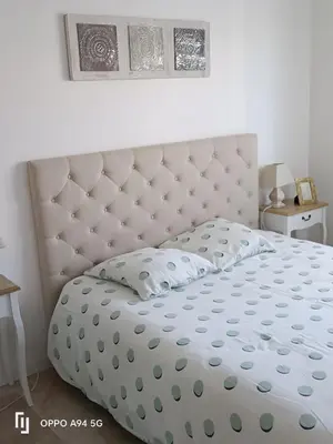 a white bed with a large headboard in a bedroom at Maison Neuf en Provence in Monteux