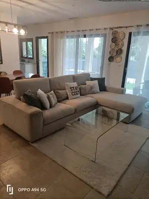 a living room with a couch and a glass table at Maison Neuf en Provence in Monteux