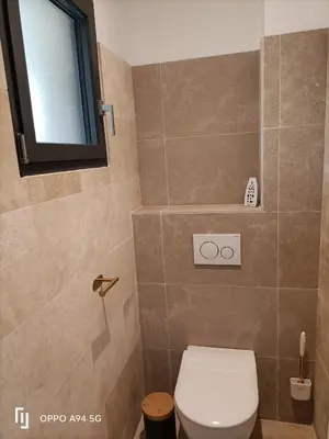 a bathroom with a toilet and a window at Maison Neuf en Provence in Monteux