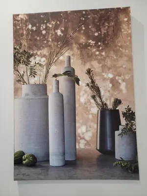 three white bottles sitting on a table with plants at Gîte au pied du mont ventoux in Bédoin