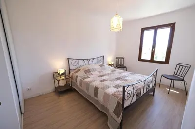 a bedroom with a bed and two chairs and a window at Air-conditioned house in the Luberon with heated swimming pool in Saint Saturnin les Apt - 8 people. in Saint-Saturnin-les-Apt