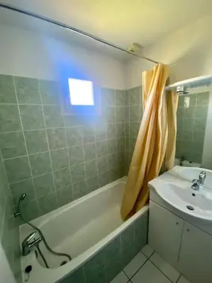 a bathroom with a sink and a bath tub and a sink at T2 Résidence Sun Hols les Rives du Lac piscine, jardin in Saint-Saturnin-lès-Avignon