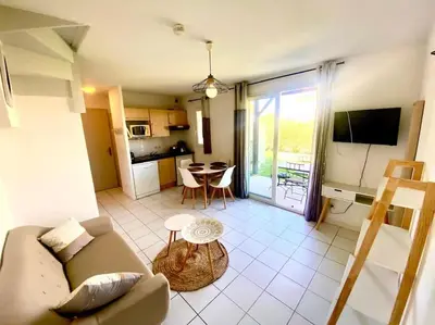a living room with a couch and a table at T2 Résidence Sun Hols les Rives du Lac piscine, jardin in Saint-Saturnin-lès-Avignon