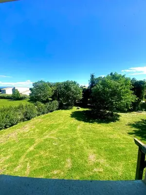 a grassy hill with a bench in a field at T2 Résidence Sun Hols les Rives du Lac piscine, jardin in Saint-Saturnin-lès-Avignon
