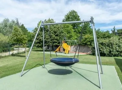 a swing set with a person on it at T2 Résidence Sun Hols les Rives du Lac piscine, jardin in Saint-Saturnin-lès-Avignon
