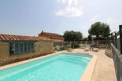 a swimming pool in front of a house at Gîte de charme avec Piscine dans le Luberon au Domaine Artemiss in Apt