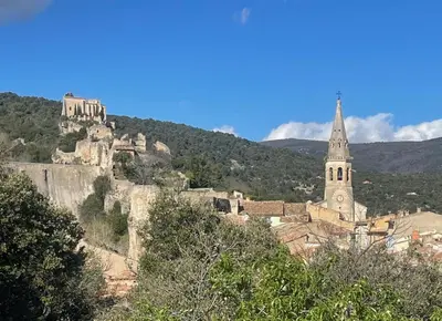 a town with a castle and a church on a mountain at La Farigoulette - Vieux village in Saint-Saturnin-les-Apt