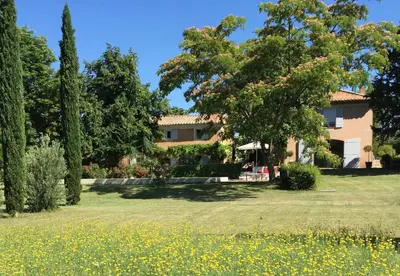 a house in the middle of a field of flowers at Mas provencal XIXème siécle avec piscine in Aix-en-Provence
