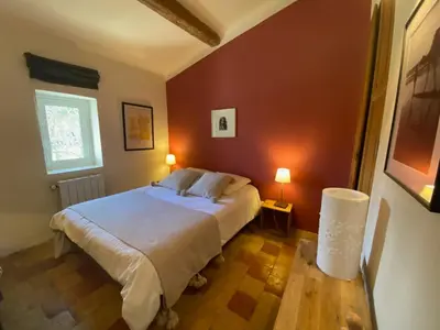 a bedroom with two beds and a window at Mas provencal XIXème siécle avec piscine in Aix-en-Provence