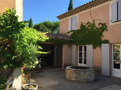 a house with a courtyard in front of it at Mas provencal XIXème siécle avec piscine in Aix-en-Provence