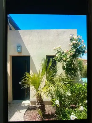 a building with a door and some plants and flowers at Studio Terrasse Privée Jardin Air conditionné in Aix-en-Provence