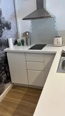 a kitchen with a sink and a bar with stools at Mazarin Suite Centre ville historique proche cours Mirabeau in Aix-en-Provence