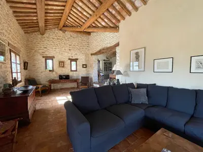 a living room with a blue couch and a table at Villa Helios in Rustrel