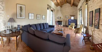 a living room with a blue couch and a table at Villa Helios in Rustrel