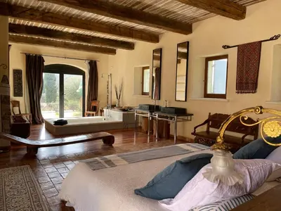 a large room with a bathroom with a bath tub at Villa Helios in Rustrel