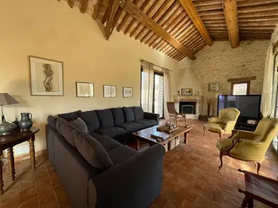 a living room with a couch and a tv at Villa Helios in Rustrel