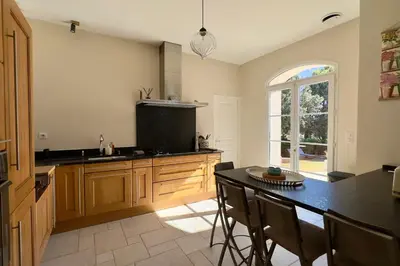a kitchen counter with a toaster and a toaster at Les Lauriers Roses air-conditioned villa with garden and swimming pool in Saumane-de-Vaucluse
