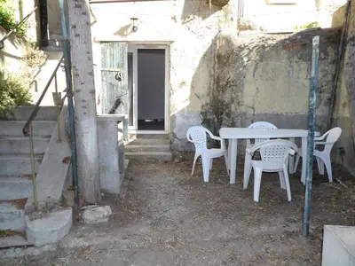 a table and chairs sitting outside of a building at Studio chez Steph in Eyguières