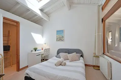 a bedroom with a bed with two pillows on it at Grande villa avec piscine près d'Avignon - Jonquerettes in Jonquerettes