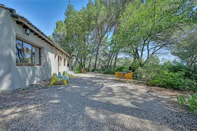 a group of chairs sitting next to a building at Grande villa avec piscine près d'Avignon - Jonquerettes in Jonquerettes