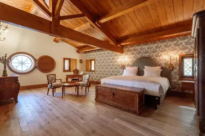 a bedroom with a large bed and a wooden ceiling at Domaine Jourdan in Le Puy-Sainte-Réparade