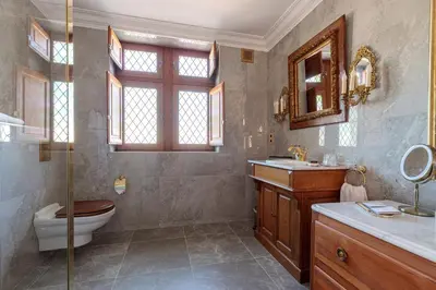 a bathroom with a toilet and a sink and a mirror at Domaine Jourdan in Le Puy-Sainte-Réparade