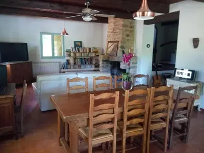 a kitchen and dining room with a table and chairs at Maison à Ansouis Luberon in Ansouis