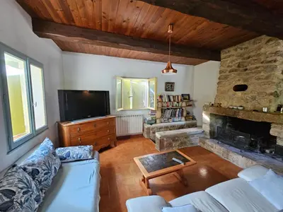 a living room with a couch and a fireplace at Maison à Ansouis Luberon in Ansouis