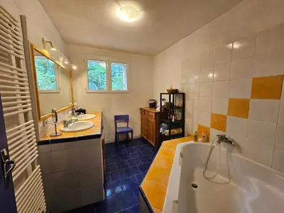 a bathroom with a tub and a sink at Maison à Ansouis Luberon in Ansouis