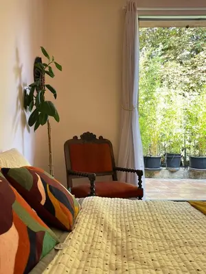 a bedroom with a bed and a chair and a window at Aix center in Aix-en-Provence