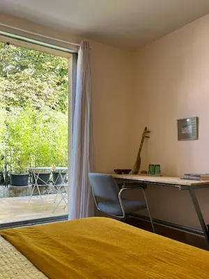 a bedroom with a desk and a window with a giraffe on the wall at Aix center in Aix-en-Provence