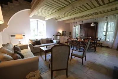 a living room with a couch and a table at Provencal Farm with swimming pool near Isle sur la Sorgue - 10 people. in Les Vignères
