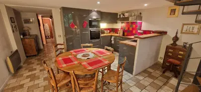 a kitchen with a table and chairs in a kitchen at Le Jardin secret 100m Mairie in Aix-en-Provence