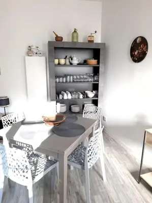 a dining room with a table and chairs at Appartement Au Murmure des Eaux à Fontaine-de-Vaucluse in Fontaine-de-Vaucluse