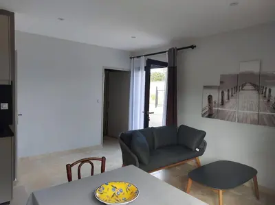 a living room with a couch and a table at Location indépendante au cœur des Alpilles pour 2 personnes avec Jacuzzi in Aureille