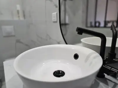 a white sink sitting on a counter in a bathroom at Pic chic in Châteaurenard