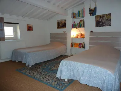 a bedroom with two beds and a window at La Grange des Davids Mas en Provence in Oppedette