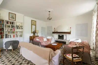 a living room with a couch and chairs and a fireplace at La Grange des Davids Mas en Provence in Oppedette