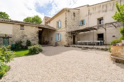 an exterior view of a stone house with a patio at La Grange des Davids Mas en Provence in Oppedette