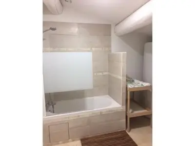 a bathroom with a bath tub in a room at Mas des Grialou, grand mas provencal de standing in Carpentras